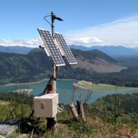 PNSN field photo, equipment with lake and mountains in background