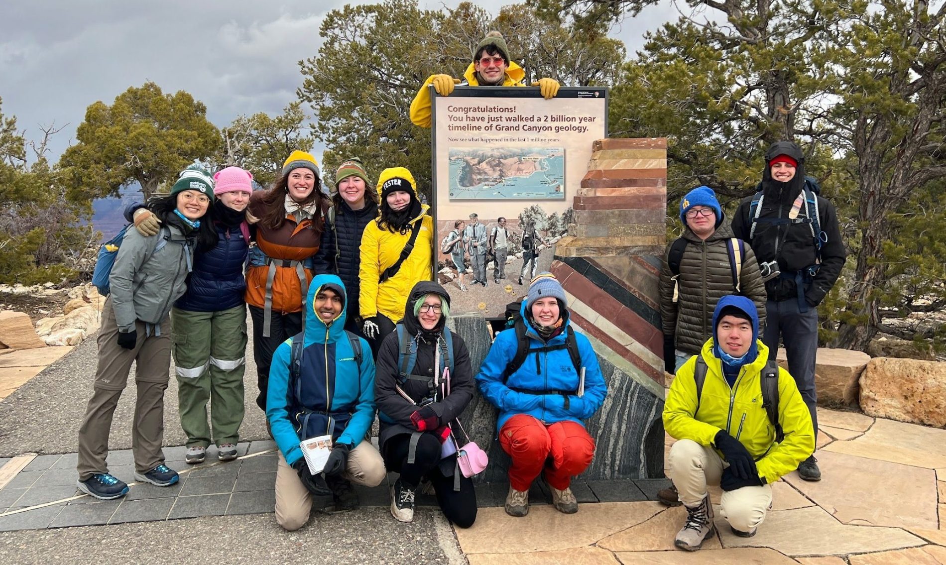 Students posing near a sign in Grand Canyon National Park during a field trip.
