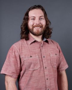 Headshot of Jonathan Gates with gray background.