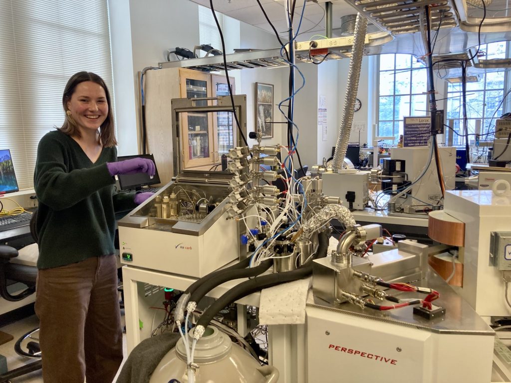 Close up of Annika Jorgenson standing next to lab instruments.