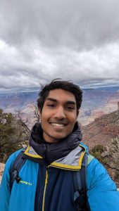 Close up of Vigash Ravi with mountains in the background.