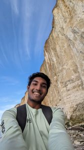 Close up of Vigash Ravi with a cliff face in the background.