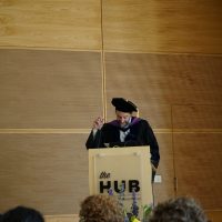 Eric Steig at a podium speaking at graduation.