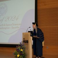 Dean Maya Tolstoy giving a speech on stage at graduation.