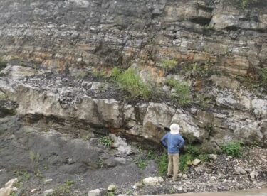 A person looks at cap carbonate rocks in South China in 2019.