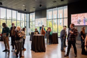 Department community members socializing at the ESS 130th Anniversary Celebration in the Burke Museum.