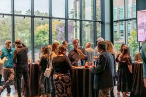Department community members socializing at the ESS 130th Anniversary Celebration in the Burke Museum.