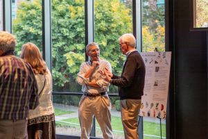 Department community members socializing at the ESS 130th Anniversary Celebration in the Burke Museum.