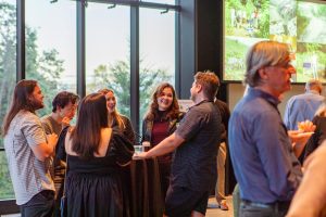 Department community members socializing at the ESS 130th Anniversary Celebration in the Burke Museum.