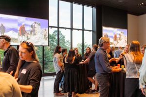 Department community members socializing at the ESS 130th Anniversary Celebration in the Burke Museum.