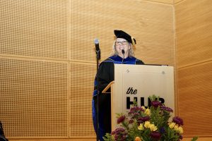 Distinguished alum speaker and Emerita Professor Kathy Troost behind the podium.