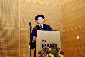 Graduate student speaker Dr. Andrew Shumway standing behind the podium.