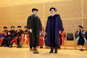 Assistant Professor Josh Krissansen-Totton and Dr. Andrew Shumway on stage after hooding.