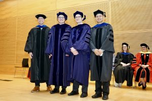 Assistant Professor Josh Krissansen-Totton, graduate Dr. Andrew Shumway, graduate Dr. Lucas Fifer, and Professor Fang-Zhen Teng standing on stage.