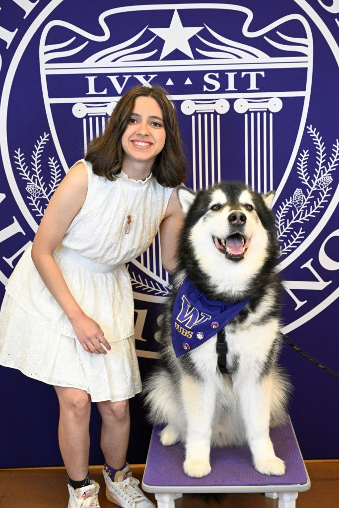 Close up of Veronica Fula posing with Dubs, the UW Husky.