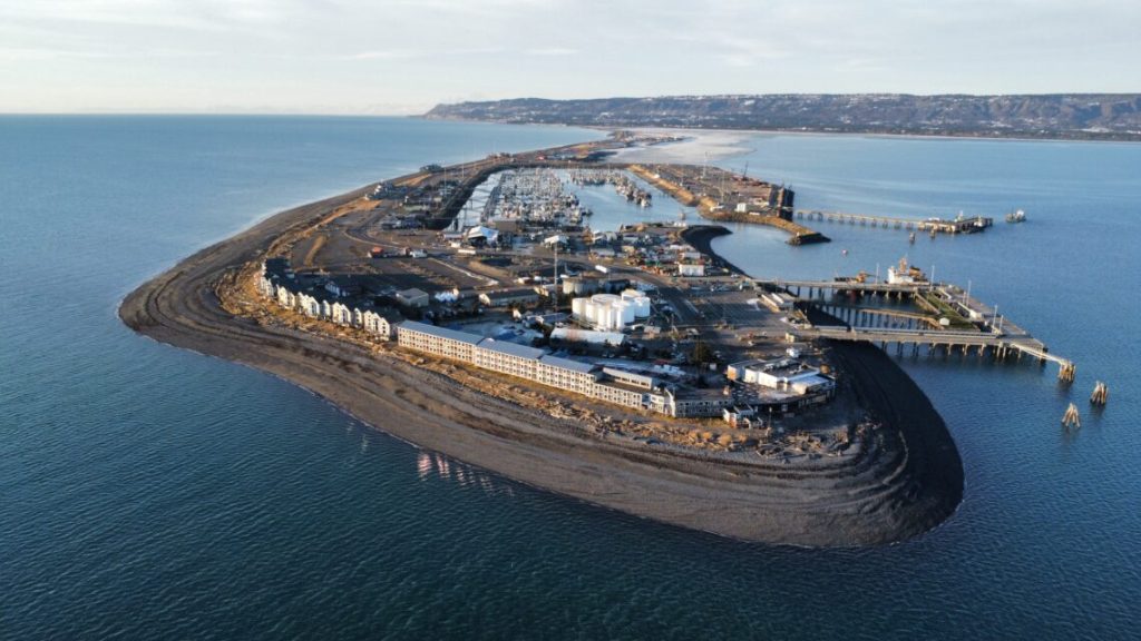 A drone photo taken from above the Homer Spit, a 4.5 mile stretch that extends into the ocean. On the left, fiber optic cables are beneath the water.
