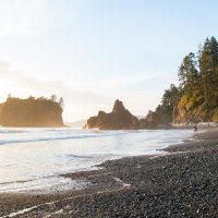 Pacific coast at sunset, waves on a rocky beach.