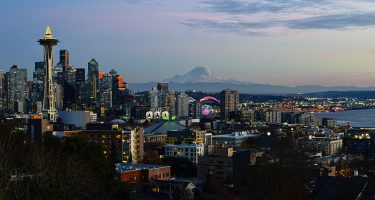 A view of the city of Seattle along with the Space Needle, downtown, Elliot Bay and Mount Rainier.