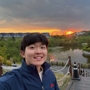 Close up of Scott Chang with sunset in the background.