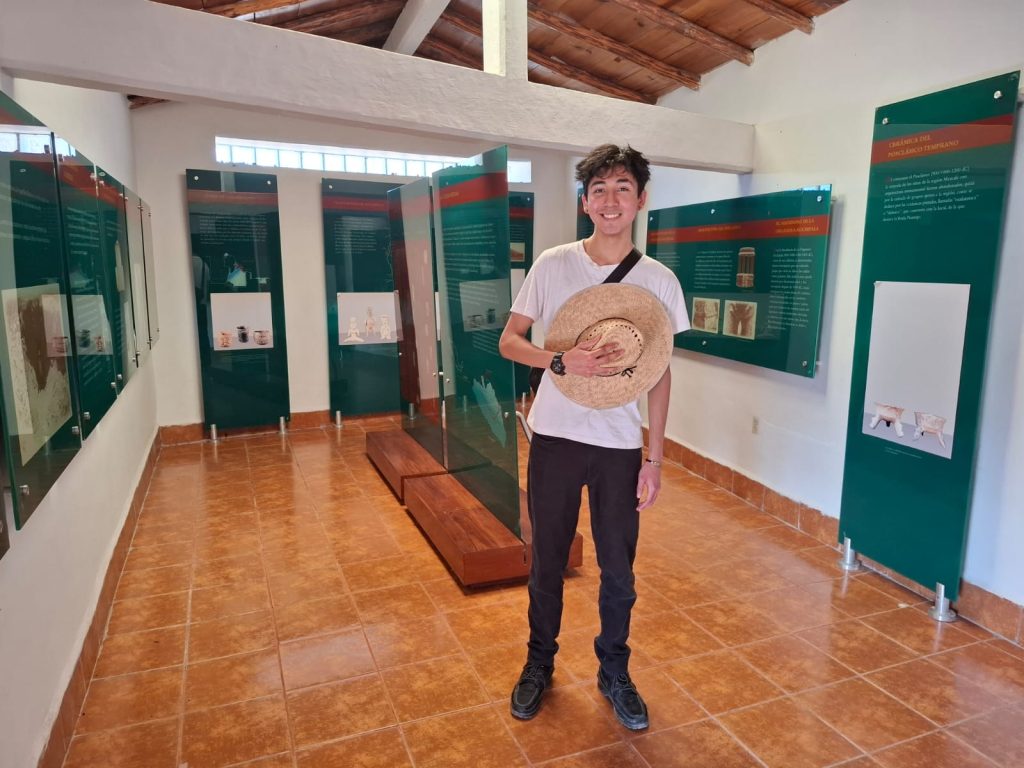 Luis Bedolla-Cruz standing in front of a museum exhibit.
