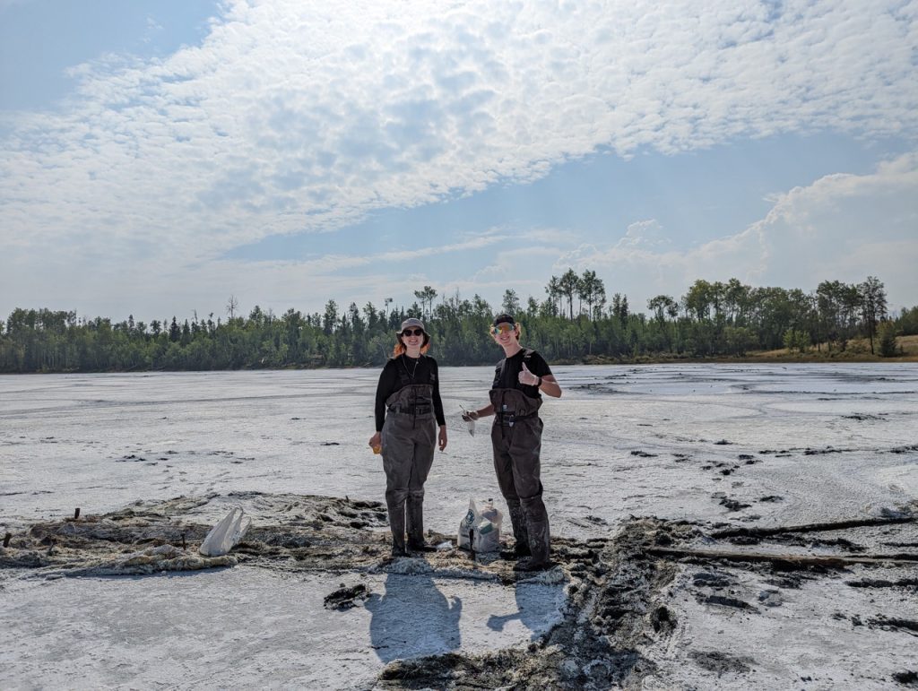 Kimberly Sinclair and Trent Thomas at a British Columbia field site during the UWAB workshop in 2022, collecting samples from a salt flat.