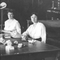 Katherine Van Winkle sitting at a table with fossils in front of her.