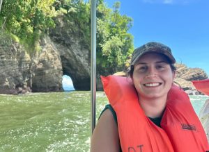 A close up of Lauren Yoson in a life vest on a boat in a river.
