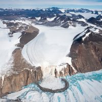 Glacial moraine surrounded by mountains.