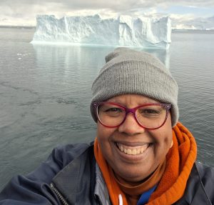 Toya Horn Howard with an iceberg in the background.