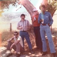 Four people posing for a photo while conducting field work.