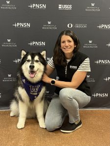 Erin Wirth posing with Dubs, the UW husky mascot.