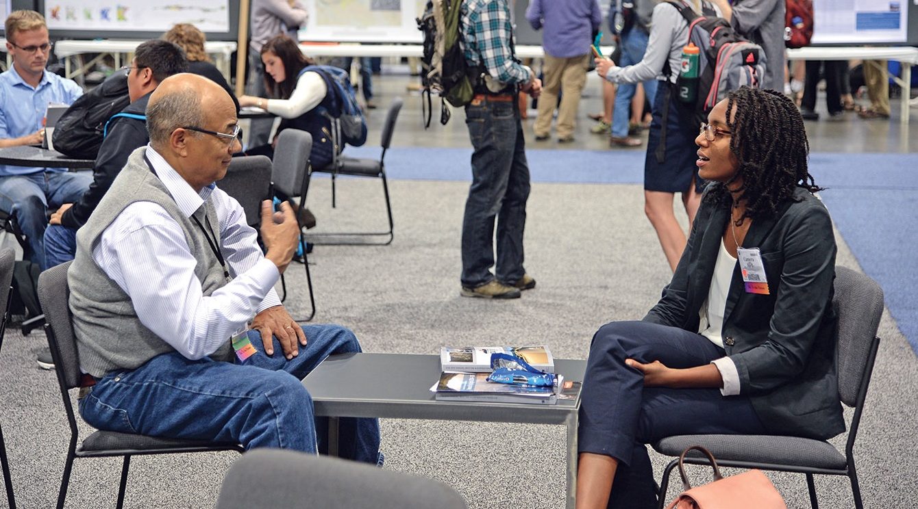 Wes Ward talking with a mentee Cameron Ford at a conference.